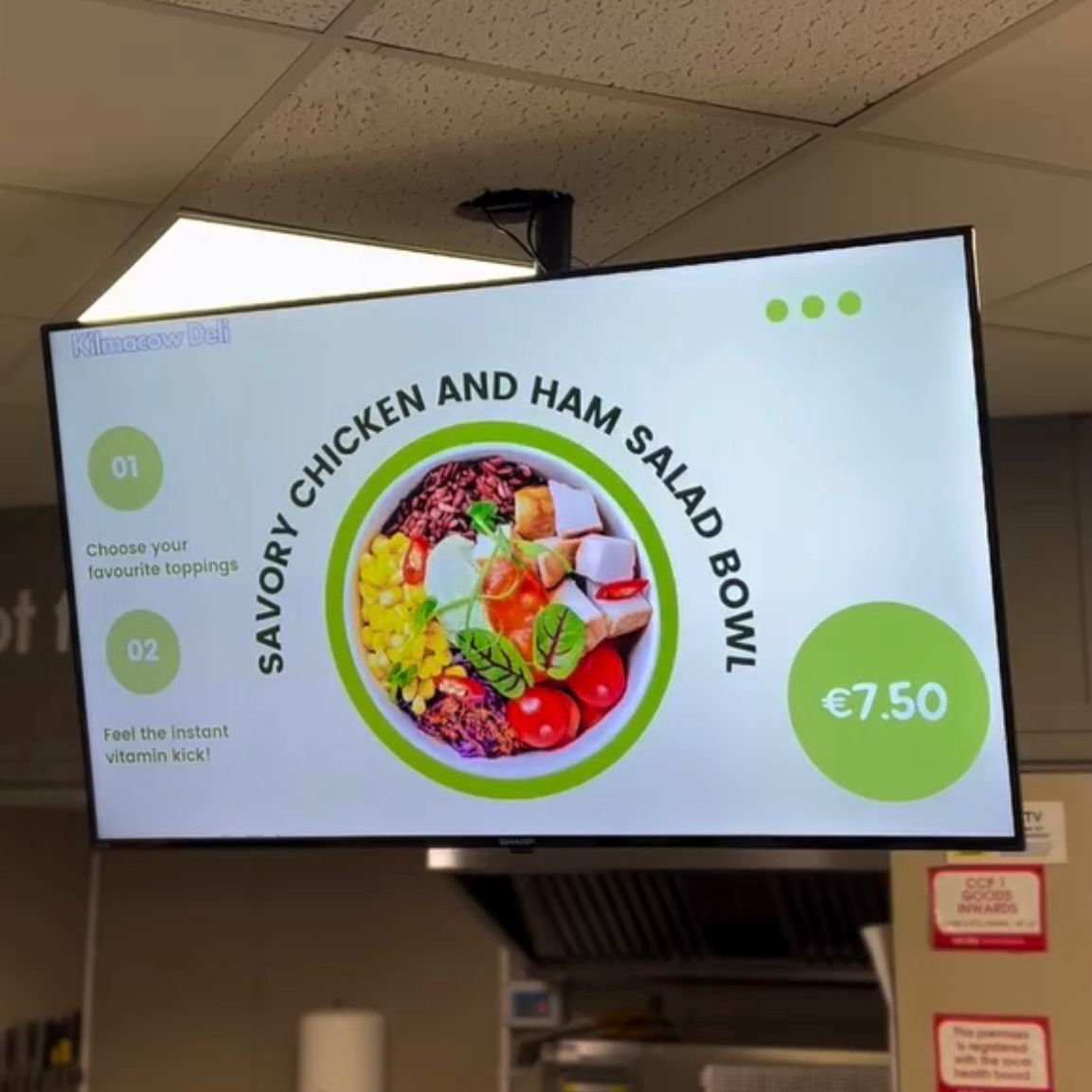 Indoor LCD digital menu screen showing a food promotion