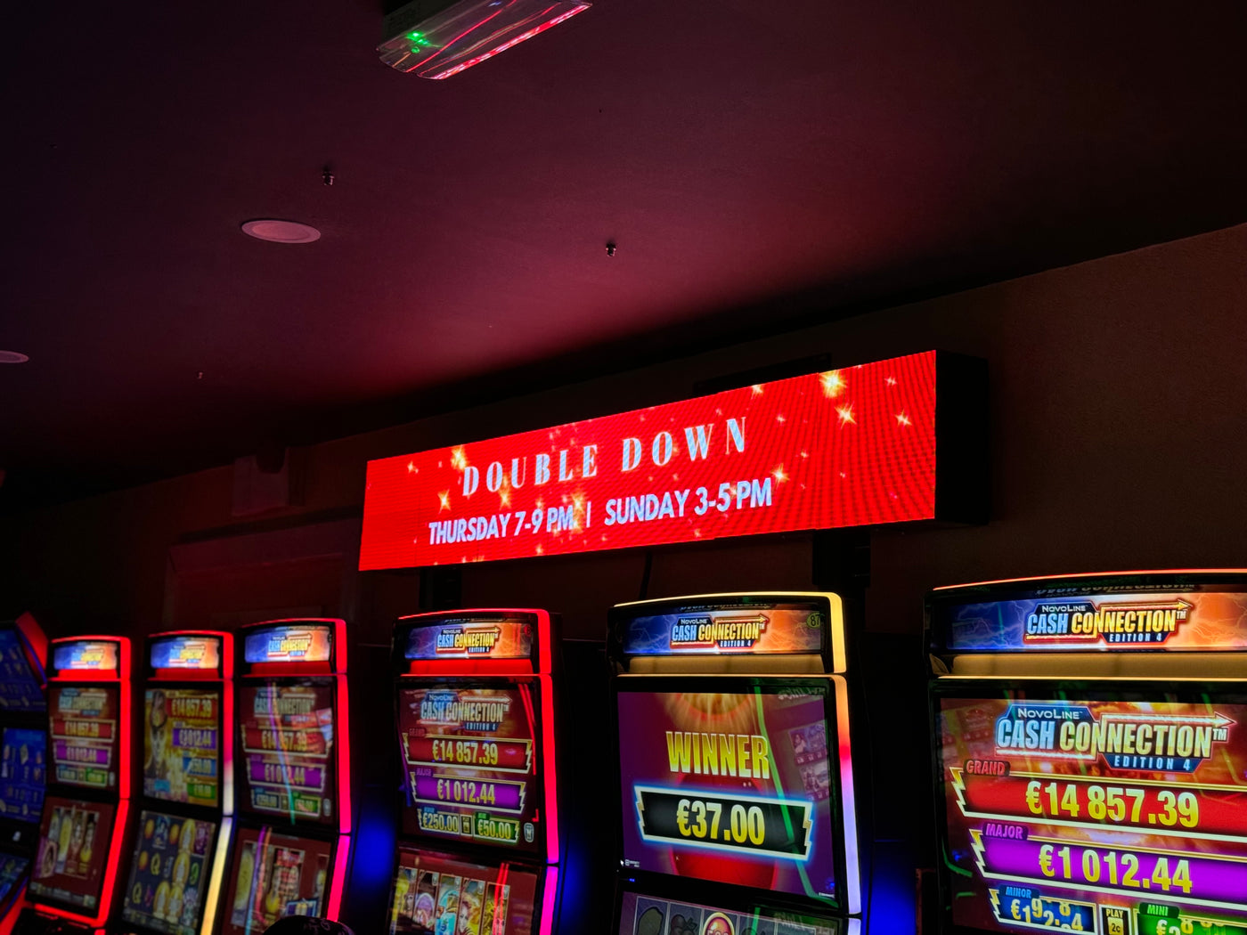 Wide LED screen installed above gaming machines